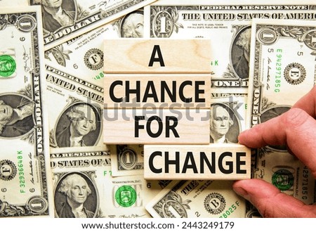 A chance for change symbol. Concept words A chance for change on beautiful wooden block. Beautiful dollar bills background. Voter hand. Dollar bills. Business A chance for change concept. Copy space.