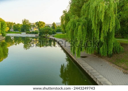 MINSK, BELARUS: Beautiful park and river in Minsk in the evening in summer Royalty-Free Stock Photo #2443249743