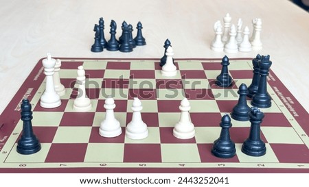 Playing chess.chess board game.Child playing chess and moving a piece in school environment. 