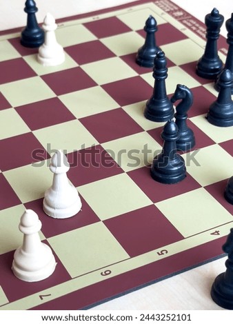 Playing chess.chess board game.Child playing chess and moving a piece in school environment. 