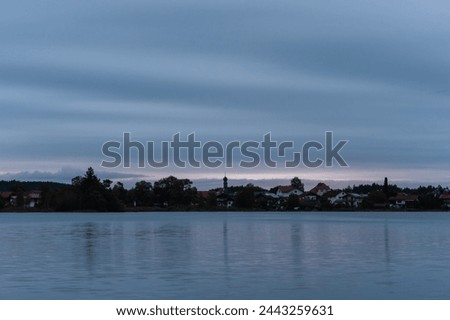 beautiful morning on the horizon over the river landscape picturing a soft cloudy sky that mirrors itself in the river