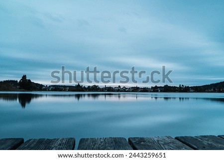beautiful morning on the horizon over the river landscape picturing a soft cloudy sky that mirrors itself in the river