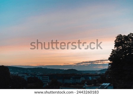 beautiful morning sunrise on the horizon over the city landscape viewing into the sky seeing natures most fantastic and colorful outdoor event with bright orange sunlight between spring and summer