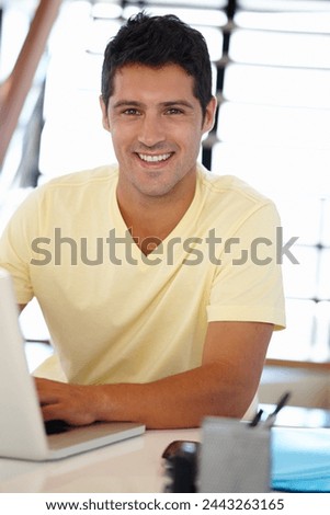 Man, smile and portrait with laptop in office for internet, research online and website for company. Young person, editor and happy with tech for typing, email and creative project for work and job