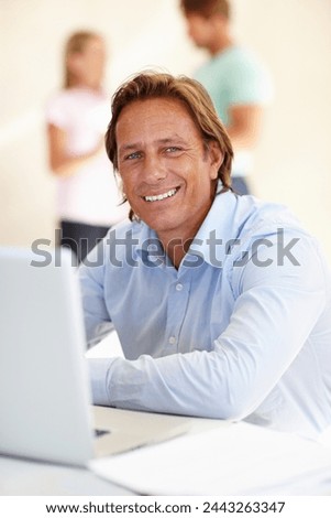 Man, smile and portrait with laptop in office for internet, research online and website for company. Mature person, editor and happy with tech for typing, email and creative project for work and job