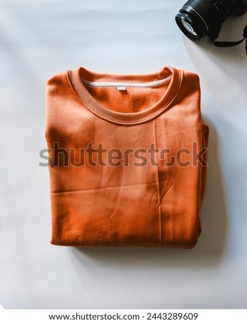 Sweatshirt with Isolated white background, Showcase style and comfort, this high-resolution image captures a vibrant orange sweatshirt laid out against a pure white background. Daska, Punjab, Pakistan