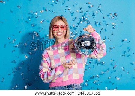 Photo of pretty young girl sunglass celebrate party hold discoball confetti wear trendy pink outfit isolated on blue color background