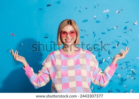 Photo portrait of pretty young girl sunglass celebrate party falling confetti wear trendy pink outfit isolated on blue color background
