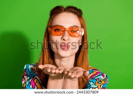 Photo portrait of attractive young woman sunglass send air kiss dressed stylish retro clothes isolated on green color background