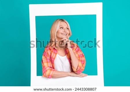 Portrait of charming lovely nice woman wear plaid trendy clothes hands hold chin empty space isolated on cyan color background