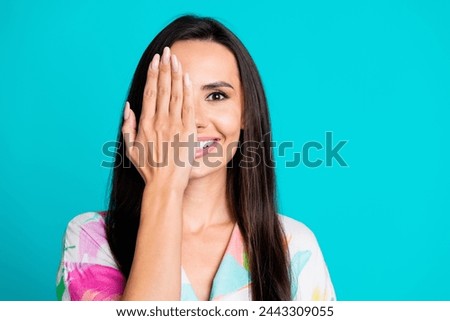 Photo of pretty young woman arm cover one eye empty space wear shirt isolated on teal color background