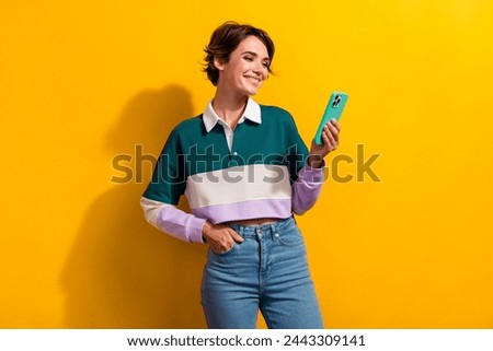 Photo of pretty nice young girl use apple iphone gadget wear shirt isolated on yellow color background