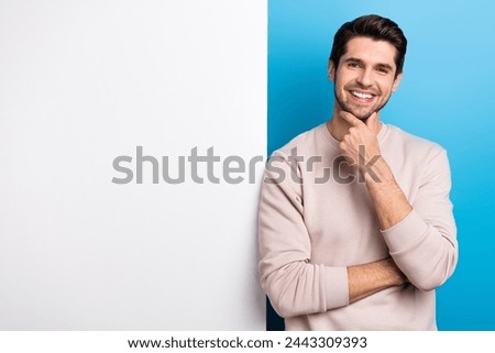 Photo of sweet thoughtful man wear beige sweatshirt arm chin poster empty space isolated blue color background Royalty-Free Stock Photo #2443309393