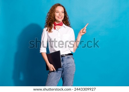 Photo portrait of pretty young woman netbook point empty space dressed stylish white clothes isolated on blue color background