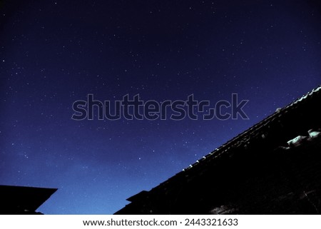 Night sky with stars above the house.
