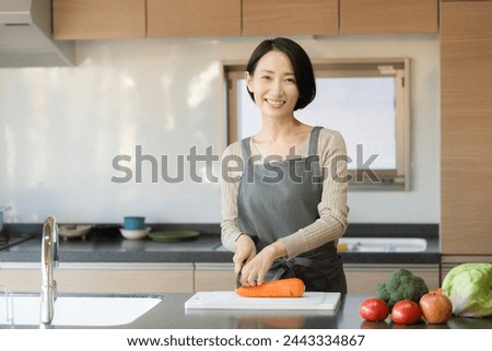 Asian (Japanese) woman cooking in a beautiful kitchen