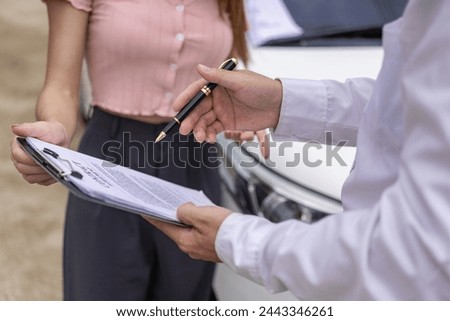 Car claim process Insurance agent after car accident writes on clipboard while inspecting car after accident claim is evaluated and processed Close-up pictures