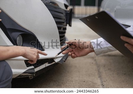 Car claim process Insurance agent after car accident writes on clipboard while inspecting car after accident claim is evaluated and processed Close-up pictures