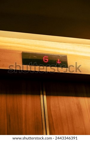 “Modern Elevator with Clear LED Floor Readout”: The sleek LED panel provides a concise visual representation of the floor progression. Royalty-Free Stock Photo #2443346391