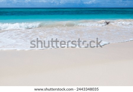 close-up of the blue summer sky and beach sand. panoramic view of the beach. Seascape and tropical beach deserted. Summertime mood, gentle sand, peace, tranquility, and soothing sunlight