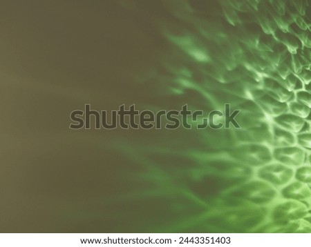 Green reflections from glass on a white background at night for a minimalist background.      