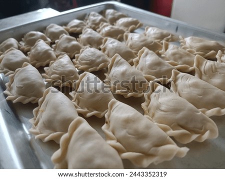 A picture of the curry cake that is in the process of being made from a slightly higher angle before it is fried and will be sold at the Ramadan bazaar sales stall.