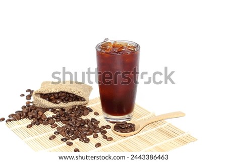Americano ice coffee and coffee beans spreading on bamboo mat with white background,isolated pictures.
