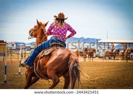 Mounted Cowgirl Racing in Rodeo