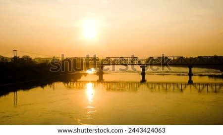 sunrise, river, golden hour, morning sun rises on top of river with big bridge with reflection on water