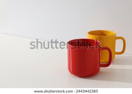 Red and yellow cups on a light background