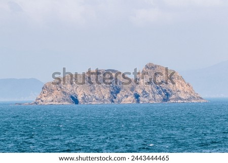 A small island surrounded by blue sea which be seen from Ganh Den lighthouse, Phu Yen Royalty-Free Stock Photo #2443444465