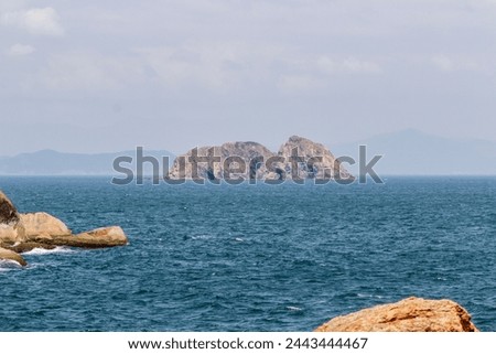 A small island surrounded by blue sea which be seen from Ganh Den lighthouse, Phu Yen Royalty-Free Stock Photo #2443444467