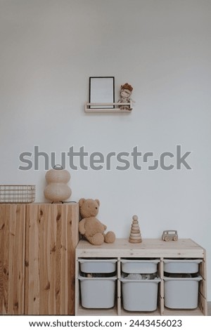 Cozy modern interior design in pastel colors. Cute gender neutral nursery room with toys, furniture and decorations
