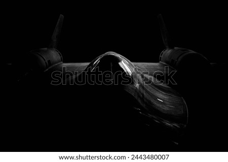 SR-71 Blackbird jet isolated on a dark background Royalty-Free Stock Photo #2443480007