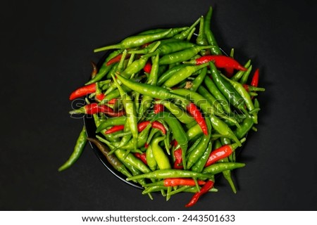 Fresh Green Chili or Chili Pepper in vegetable market scientific name is Capsicum annuum , Chili pepper is a main ingredient in many cuisines as a hot spice. It is a source of vitamin c, side top view