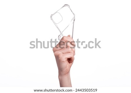 Clear iPhone 15 Plus case bent in a female hand, isolated on white background. Silicone case mockup