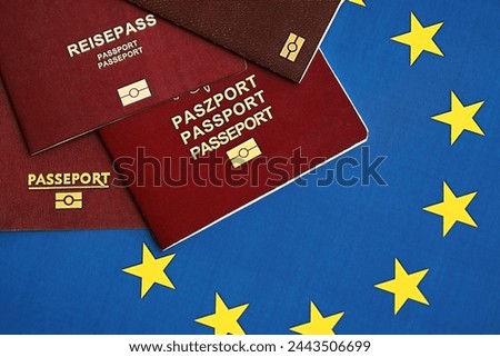 European union countries passports on blue EU flag close up. Portugal, German, French and Polish passports Royalty-Free Stock Photo #2443506699
