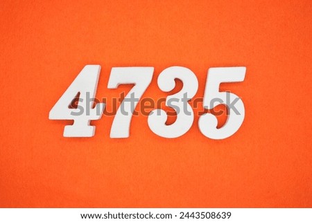 Orange felt is the background. The numbers 4735 are made from white painted wood.