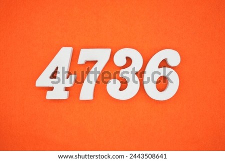 Orange felt is the background. The numbers 4736 are made from white painted wood.