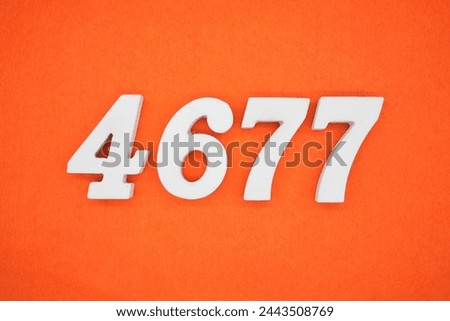 Orange felt is the background. The numbers 4677 are made from white painted wood.
