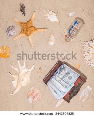 Copyspace. Money for vacation, rest, holidays. A well-deserved vacation at an expensive seaside resort. USA dollars in the chest on the sand of beach. Royalty-Free Stock Photo #2443509825