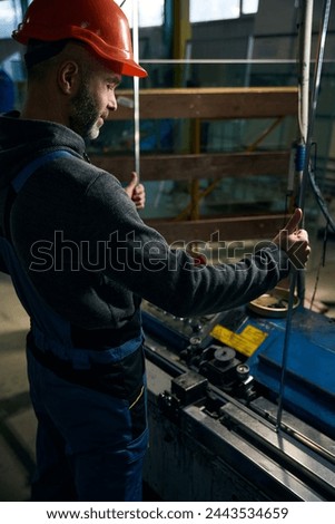 Man carries out the initial sealing of the spacer frame