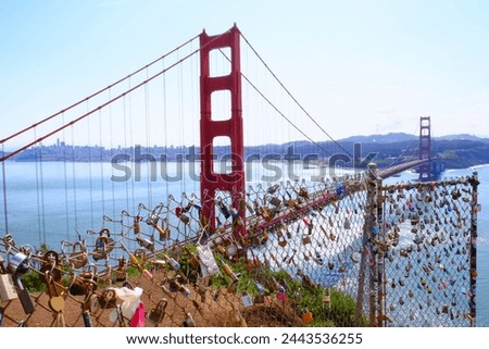 Love locks on fence of Golden Gate Bridge scenic viewpoint. Calfornia landmark. Romantic tradition. Royalty-Free Stock Photo #2443536255