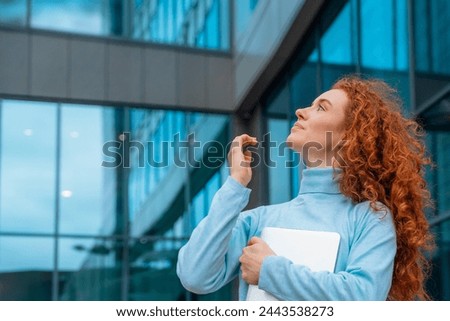a young redhead fun and huppy  woman  in white shirt talking and using on her mobile phone, using mobile in an urban modern city. Lifestyle photos