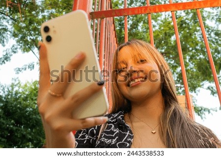 Young Latin woman with smartphone in her right hand in Neiva – Huila - Colombia