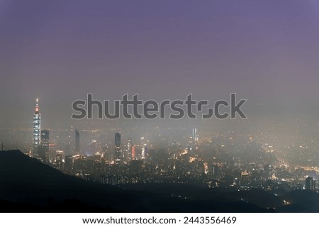 A layer of white clouds and mist over Taipei City, together with the city lights, form a colorful glazed light.