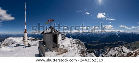 Winter view over Mount Dobratsch with the weather station and the 165m high Dobratsch Transmitter Tower. Royalty-Free Stock Photo #2443562519