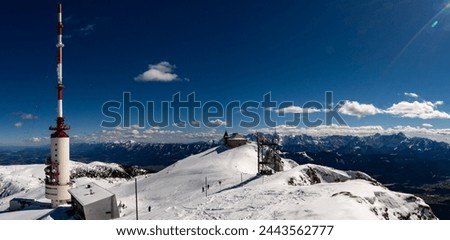 Winter view over Mount Dobratsch with the German Chapel, the summit hut and the 165m high Dobratsch Transmitter Tower. Royalty-Free Stock Photo #2443562777