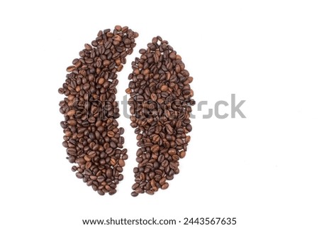 A pile of coffee beans on a white background in the shape of a cup and saucer. Top view