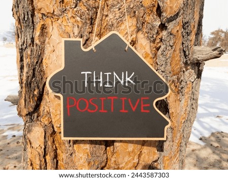 Think positive symbol. Concept words Think positive on beautiful black house blackboard. Beautiful tree background. Business, motivational think positive thinking concept. Copy space.